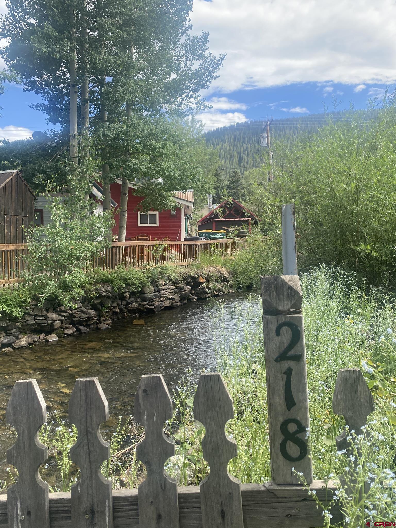 218 Maroon Avenue, Unit E Crested Butte, CO 81224 - Photo 2 of 22 a view of a lake with houses