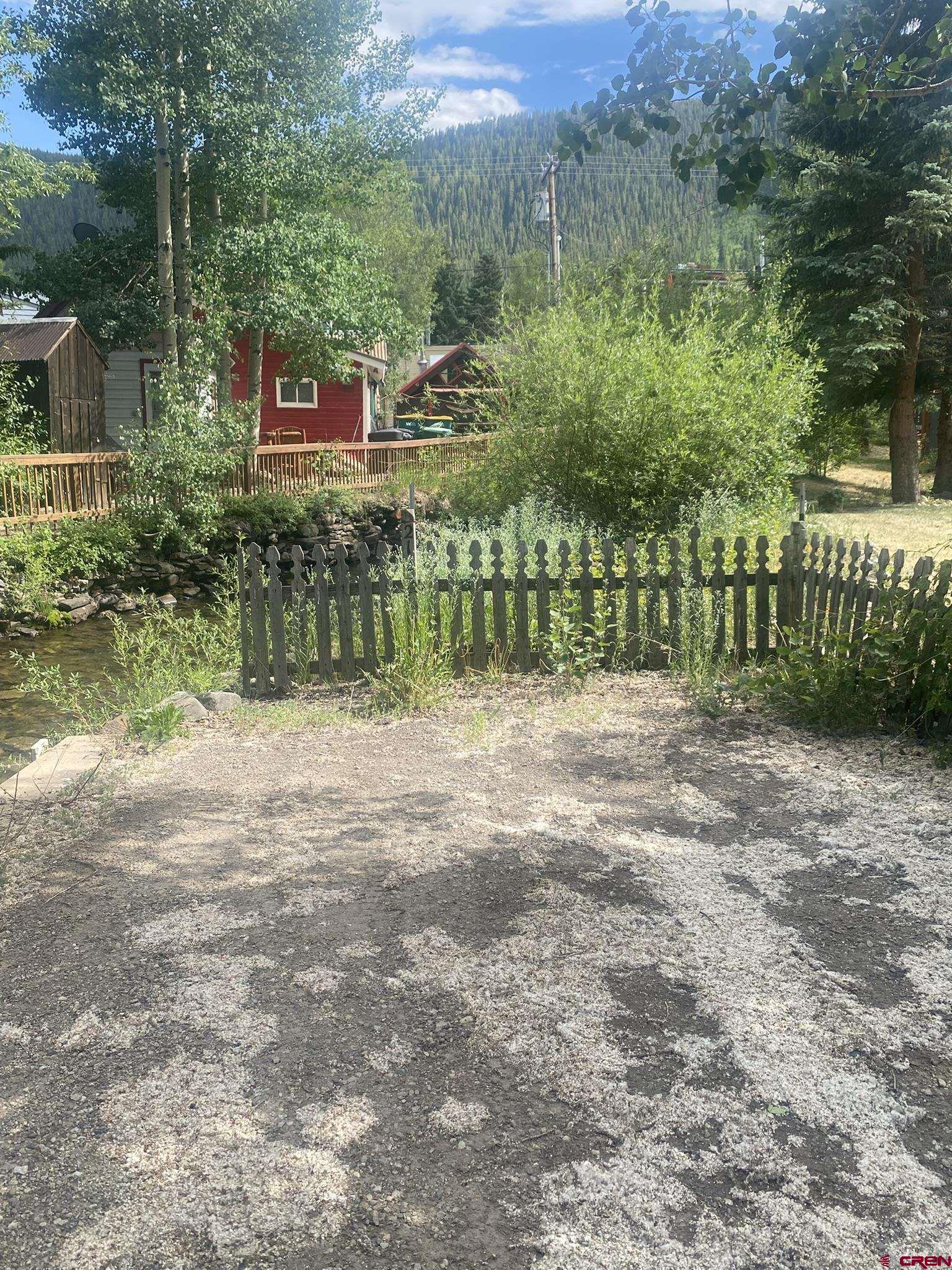 218 Maroon Avenue, Unit E Crested Butte, CO 81224 - Photo 3 of 22 a view of a park with a bench in front of the house
