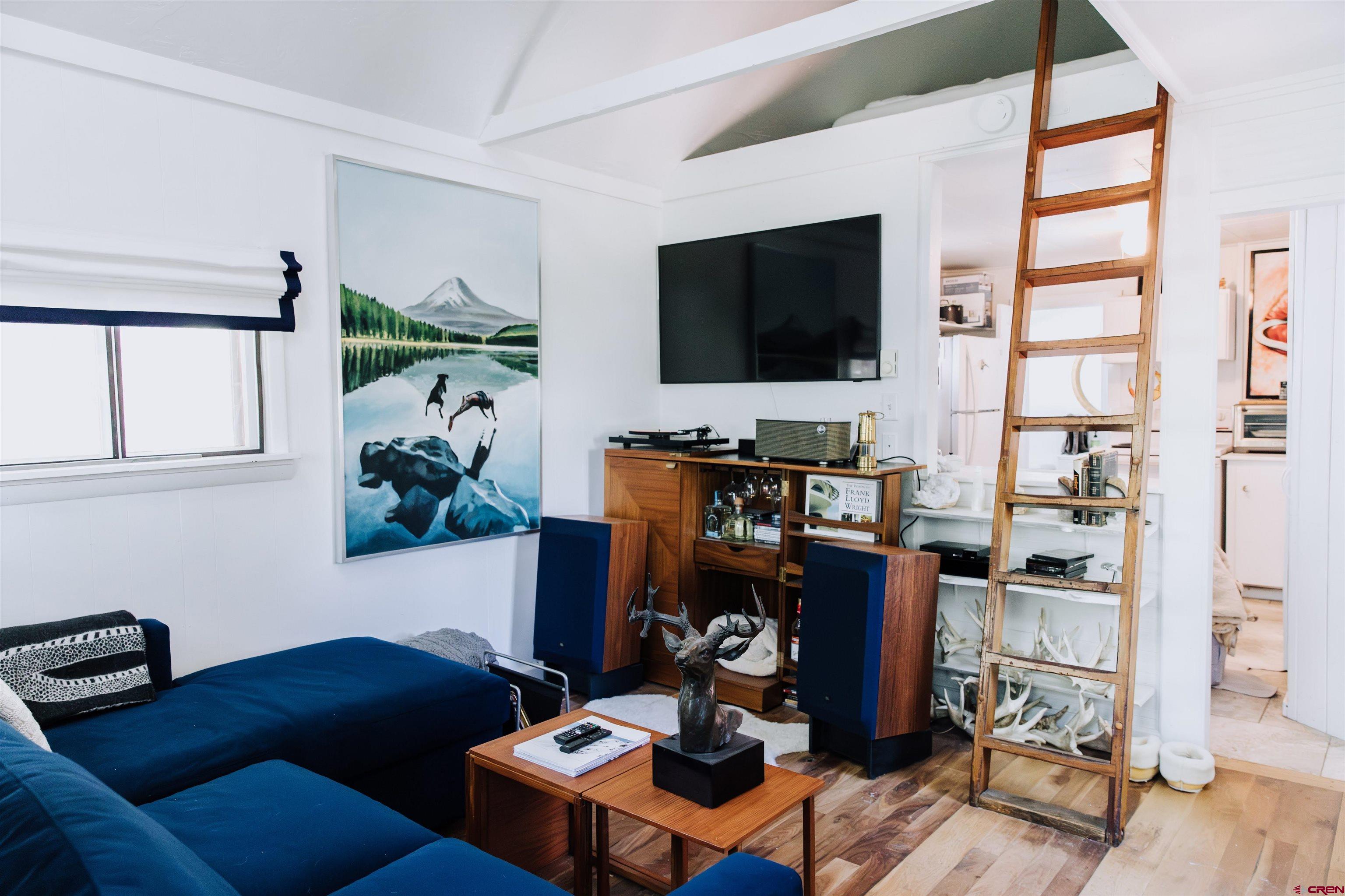 218 Maroon Avenue, Unit E Crested Butte, CO 81224 - Photo 6 of 22 a living room with furniture and a flat screen tv