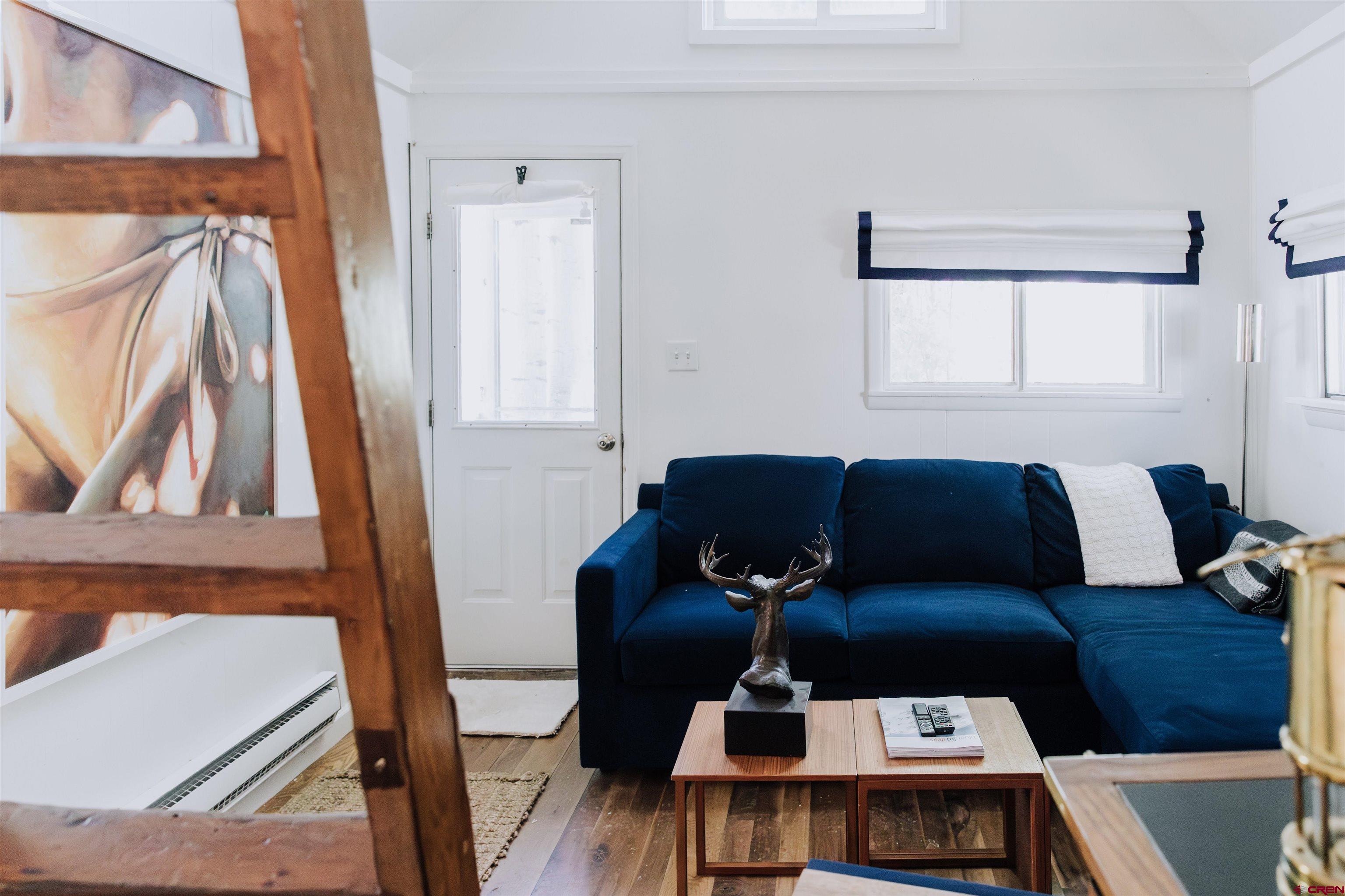 218 Maroon Avenue, Unit E Crested Butte, CO 81224 - Photo 8 of 22 a living room with a couch and a table