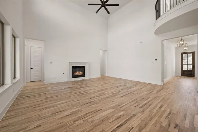 a big room with wooden floor and a ceiling fan