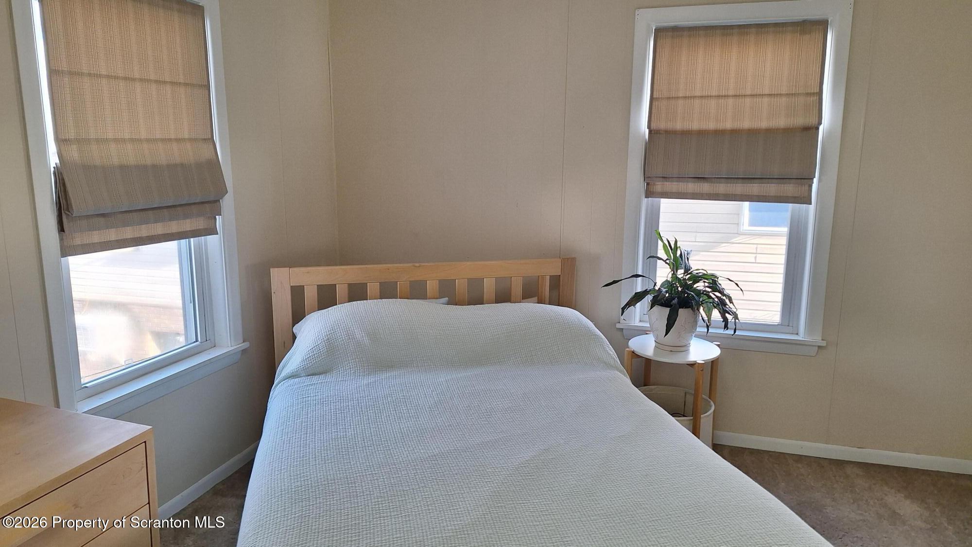 1947 Myrtle Street Scranton, PA 18510 - Photo 21 of 33 a bed sitting in a bedroom next to a window