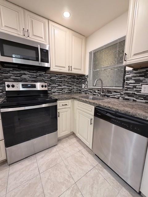 9949 Sandalfoot Boulevard, Unit 542 Boca Raton, FL 33428 - Photo 2 of 9 a kitchen with granite countertop a stove sink and cabinets