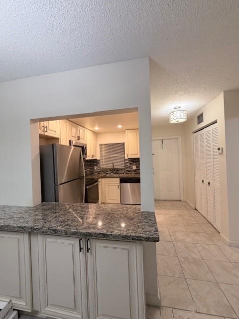 9949 Sandalfoot Boulevard, Unit 542 Boca Raton, FL 33428 - Photo 4 of 9 a kitchen with granite countertop a sink a counter top space and stainless steel appliances