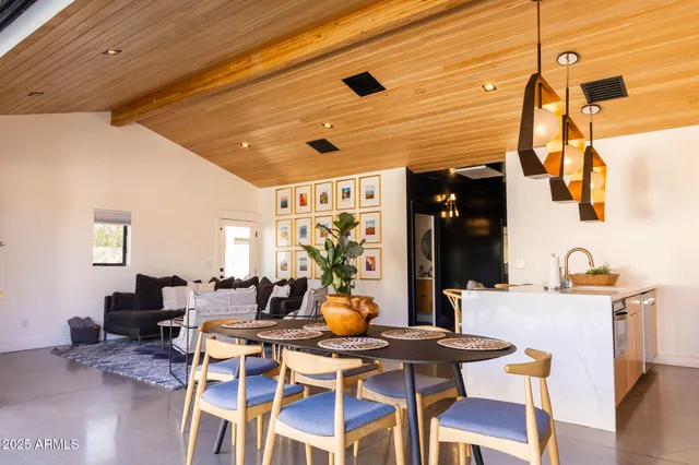 a dining room with furniture and wooden floor