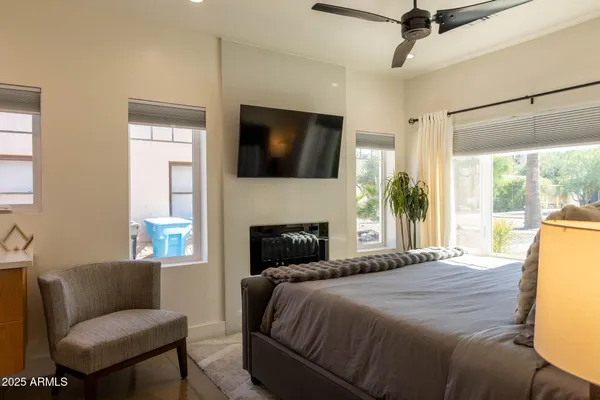 a bedroom with a bed a flat screen tv and a couch