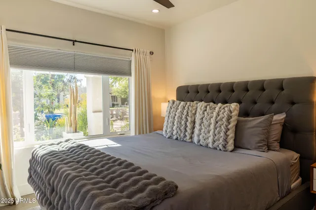 a bed sitting in a bedroom next to a window