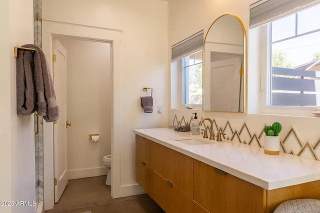 a bathroom with a sink a mirror and a shower