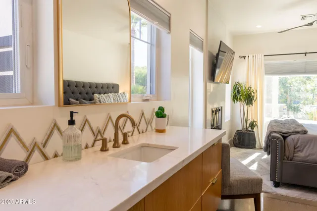 a kitchen with stainless steel appliances granite countertop a sink a stove and a refrigerator with wooden floor