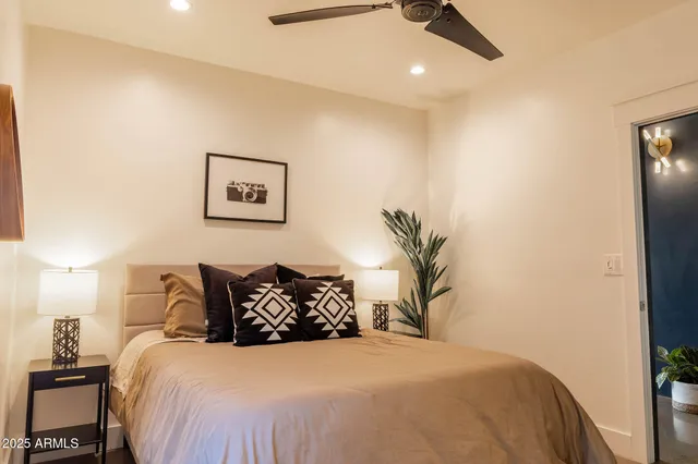a bedroom with a bed and a large window with outer view