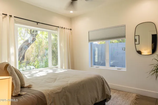 a bedroom with a bed and a painting on the wall