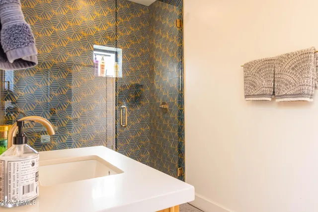 a bathroom with a shower curtain and a sink