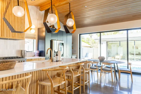 a view of a dining room with furniture wooden floor and a chandelier