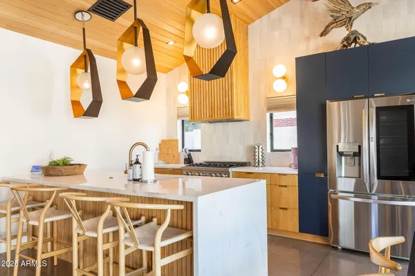 a kitchen with stainless steel appliances a sink and a refrigerator