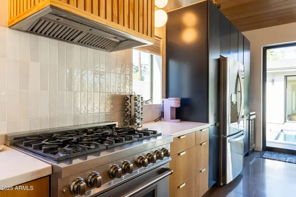 a kitchen with a stove and a refrigerator