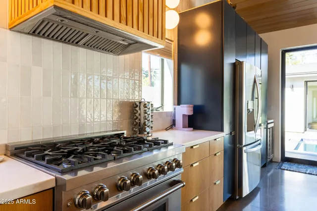 a kitchen with a stove and a refrigerator