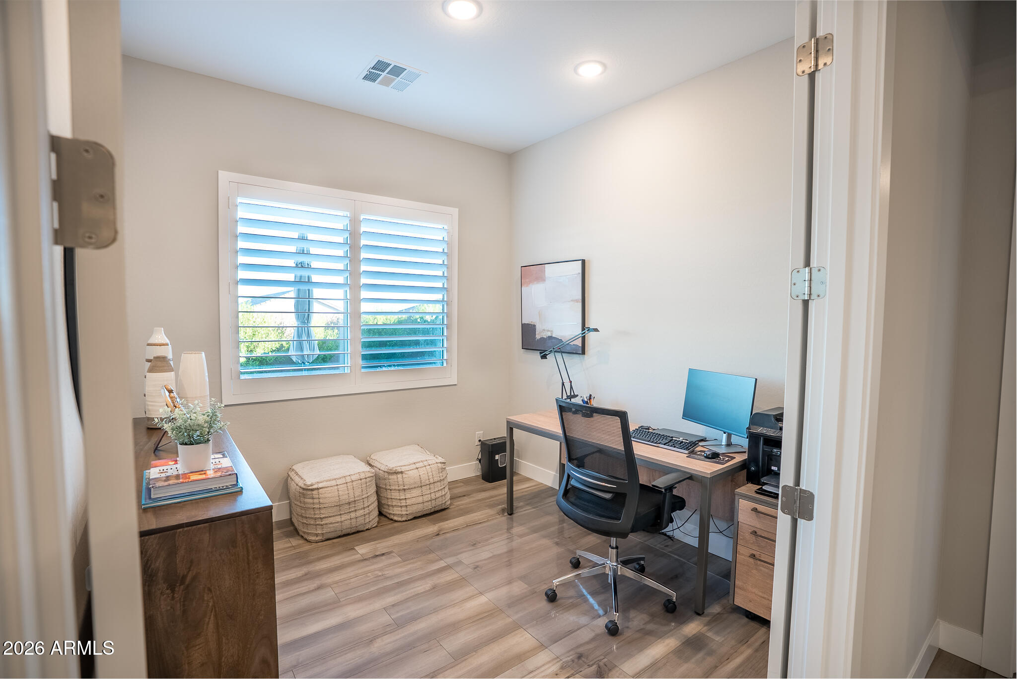 5693 206th Lane Buckeye, AZ 85396 - Photo 16 of 33 a view of a workspace with furniture and a window