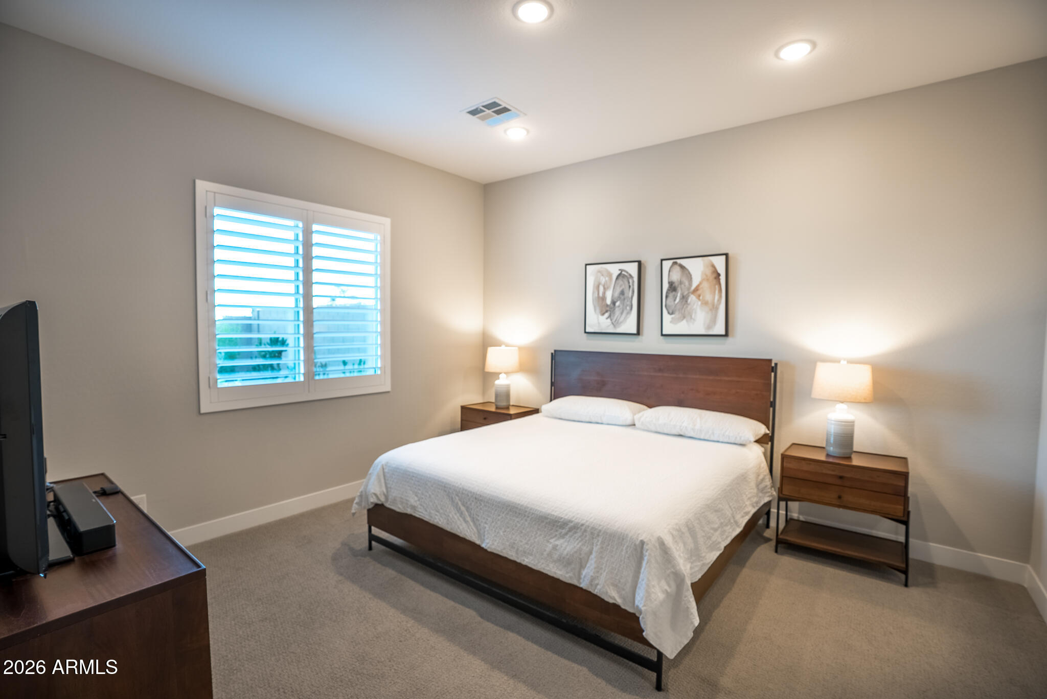 5693 206th Lane Buckeye, AZ 85396 - Photo 17 of 33 a bedroom with a bed and a night stand