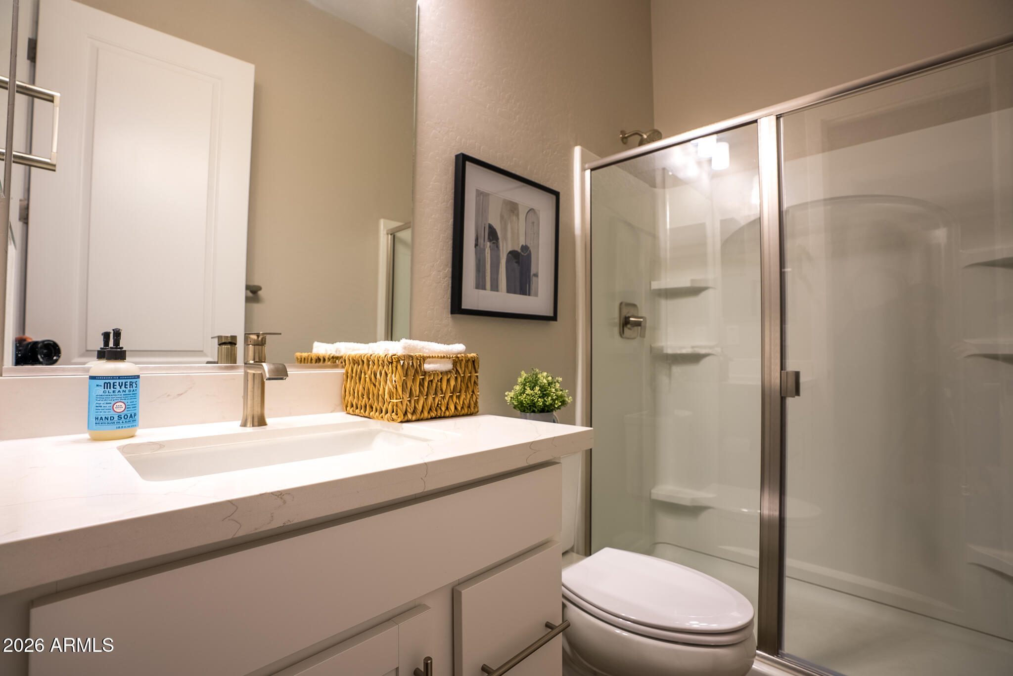 5693 206th Lane Buckeye, AZ 85396 - Photo 22 of 33 a bathroom with a sink a toilet a shower and a mirror