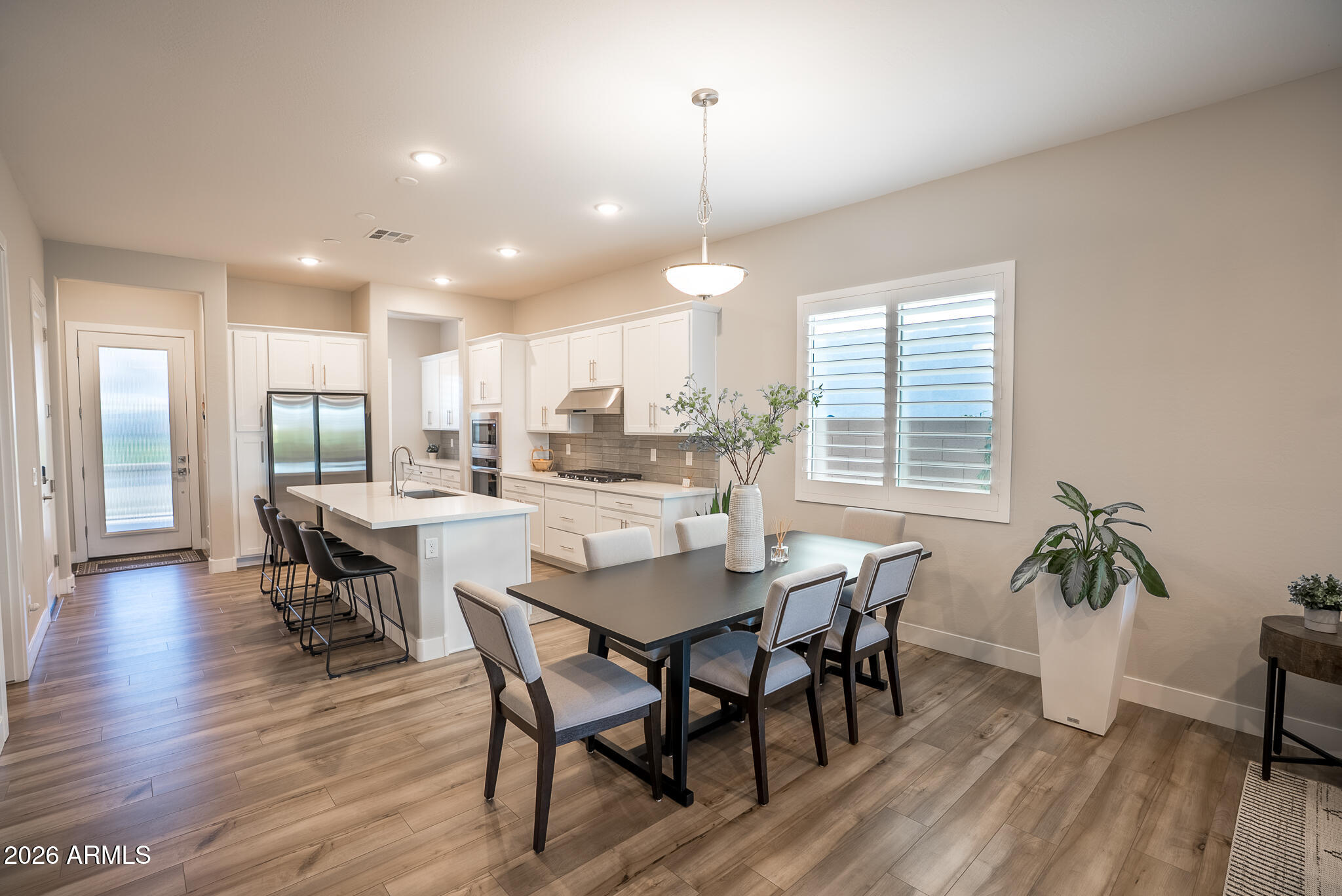 5693 206th Lane Buckeye, AZ 85396 - Photo 4 of 33 a dining room with furniture and wooden floor
