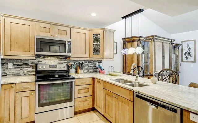 a kitchen with stainless steel appliances a stove sink and microwave