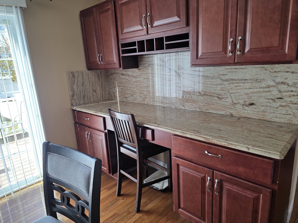 176 Oak Grove Avenue Fall River, MA 02723 - Photo 3 of 9 a kitchen with a chair a sink and a microwave