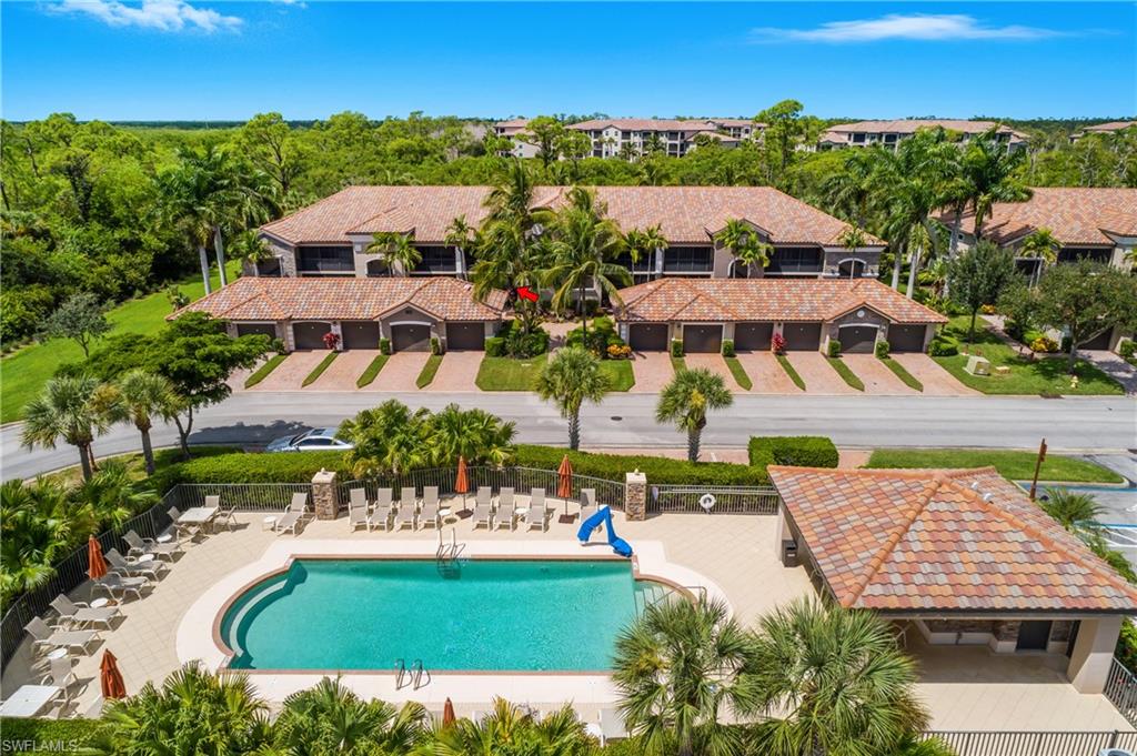 9832 Venezia Circle, Unit 1013 Naples, FL 34113 - Photo 1 of 34 an aerial view of residential houses with outdoor space and swimming pool