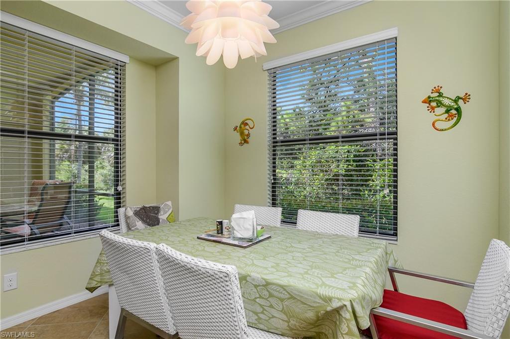 9832 Venezia Circle, Unit 1013 Naples, FL 34113 - Photo 19 of 34 a bedroom with a bed and a window