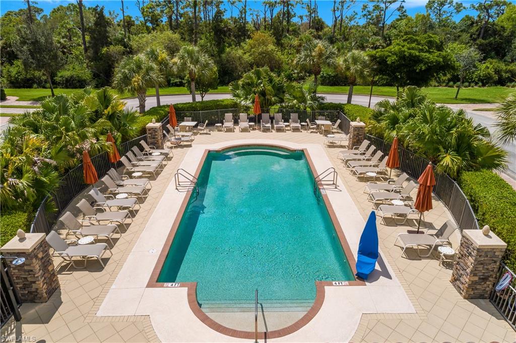 9832 Venezia Circle, Unit 1013 Naples, FL 34113 - Photo 2 of 34 a view of a backyard with sitting area