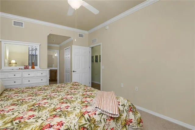 a bedroom with a large bed and a mirror on dresser