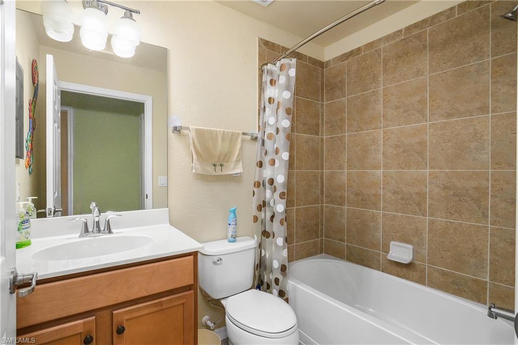 9832 Venezia Circle, Unit 1013 Naples, FL 34113 - Photo 27 of 34 a bathroom with a sink a toilet and shower