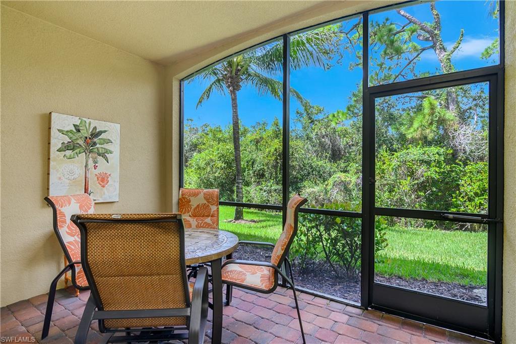 9832 Venezia Circle, Unit 1013 Naples, FL 34113 - Photo 28 of 34 a view of a city from a dining room with large windows