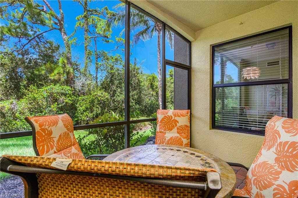 9832 Venezia Circle, Unit 1013 Naples, FL 34113 - Photo 29 of 34 a outdoor space with the couches and dining table