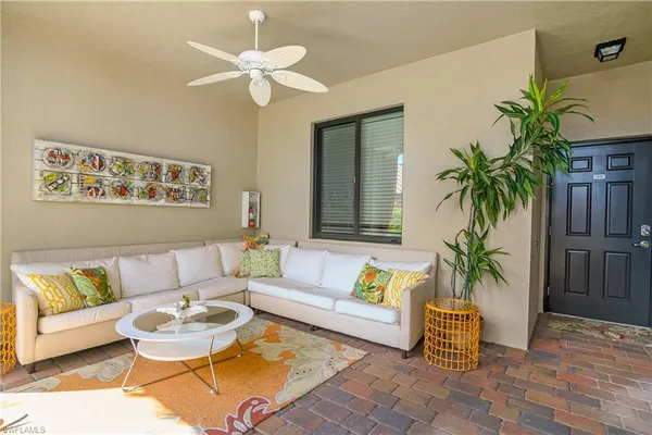 a living room with furniture and a potted plant