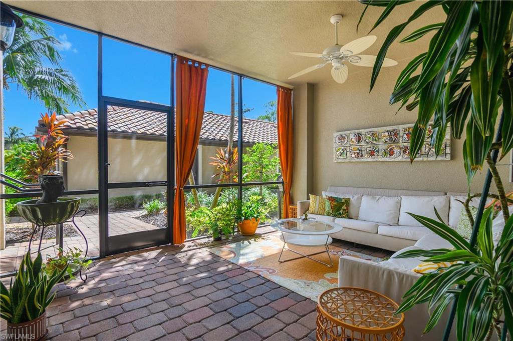 9832 Venezia Circle, Unit 1013 Naples, FL 34113 - Photo 6 of 34 a living room with furniture and a potted plant