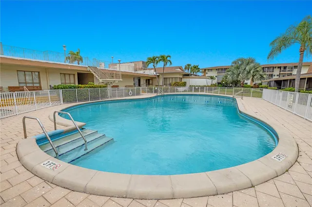 a view of a swimming pool with an outdoor seating
