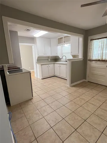 a kitchen with a cabinets and white appliances