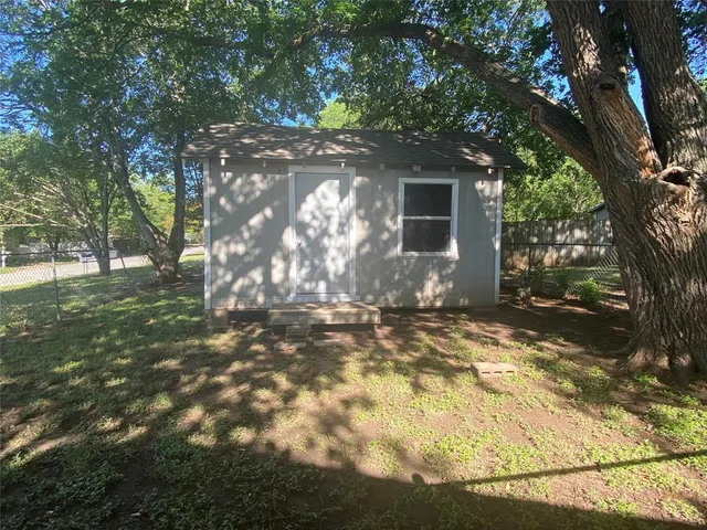 a view of a house with a tree