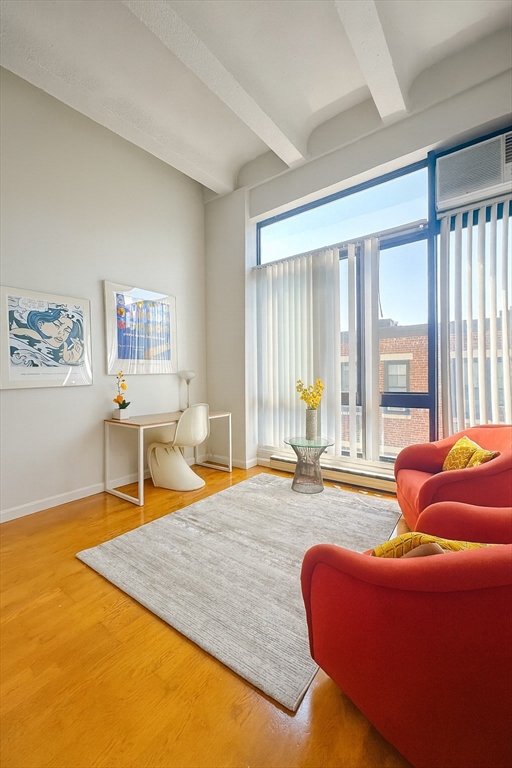12 Stoneholm Street, Unit 529 Boston, MA 02115 - Photo 1 of 11 a living room with furniture and large windows