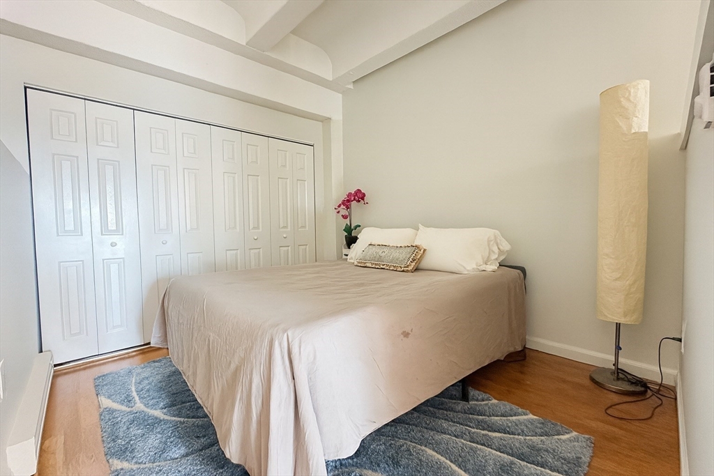 12 Stoneholm Street, Unit 529 Boston, MA 02115 - Photo 4 of 11 a bedroom with a bed and a window