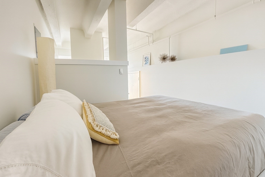 12 Stoneholm Street, Unit 529 Boston, MA 02115 - Photo 5 of 11 a view of a bedroom with wooden floor