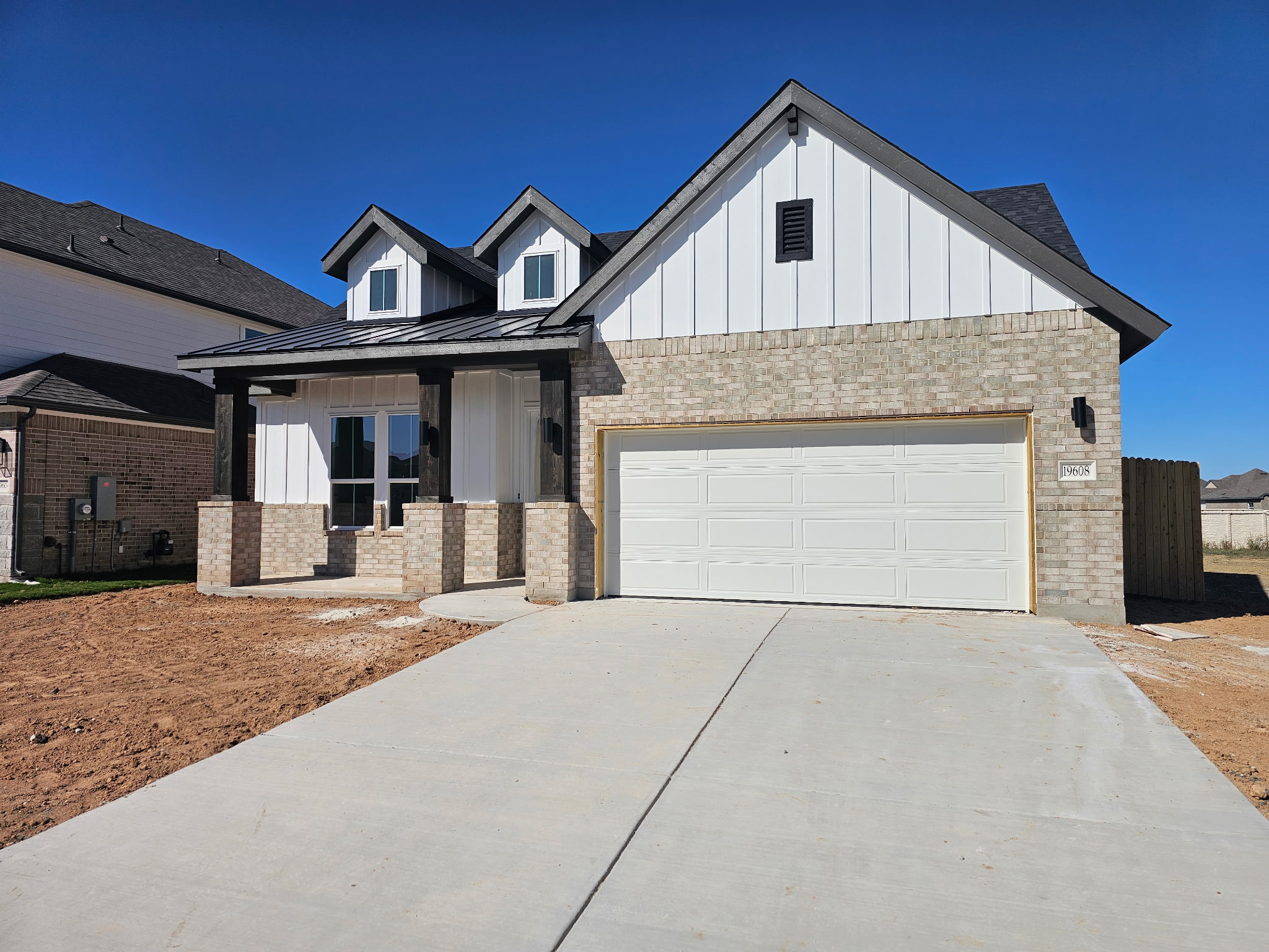 a front view of a house with yard and garage