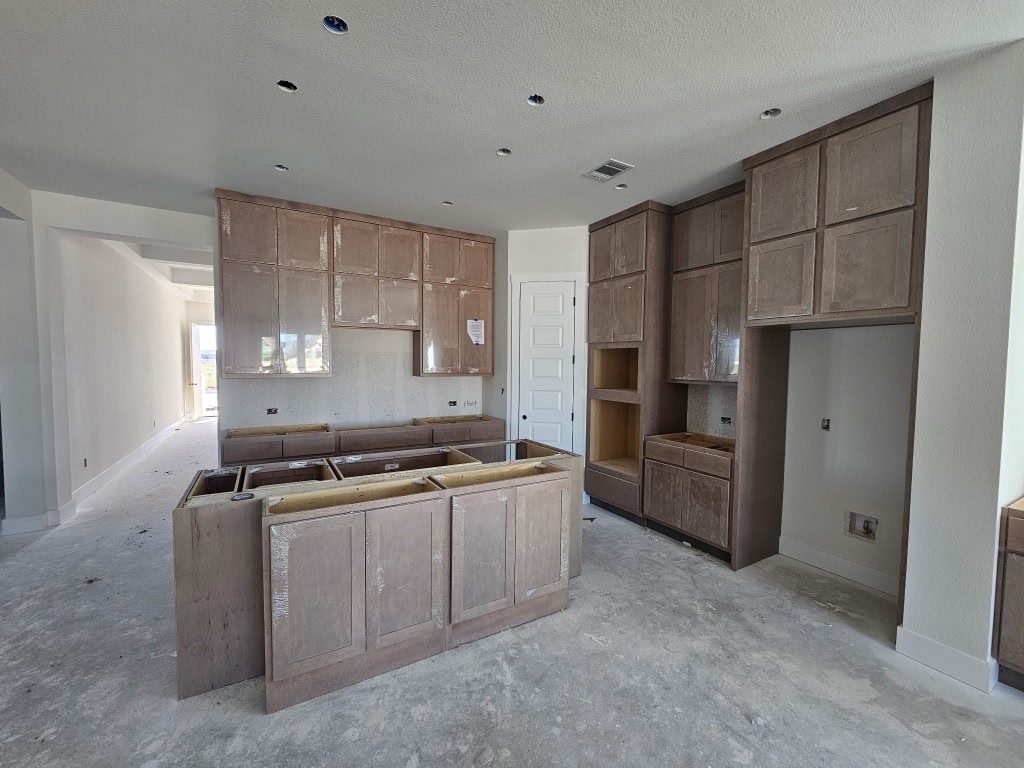 19608 Domino Champ Road Pflugerville, TX 78660 - Photo 3 of 14 a kitchen with stainless steel appliances granite countertop a stove a refrigerator and a refrigerator