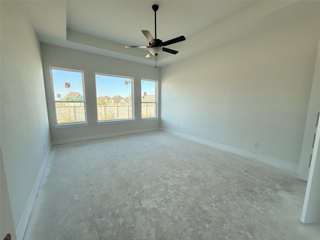 19608 Domino Champ Road Pflugerville, TX 78660 - Photo 6 of 14 a view of a room with window a ceiling fan and windows