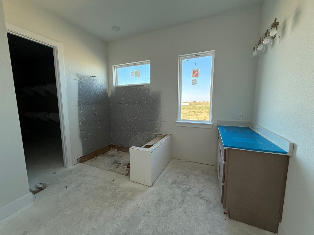 19608 Domino Champ Road Pflugerville, TX 78660 - Photo 8 of 14 an empty room with windows