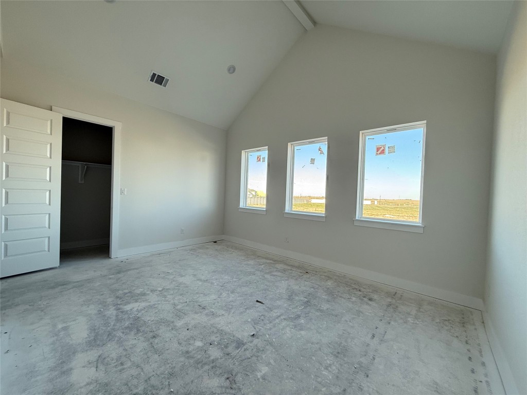 19608 Domino Champ Road Pflugerville, TX 78660 - Photo 9 of 14 an empty room with windows