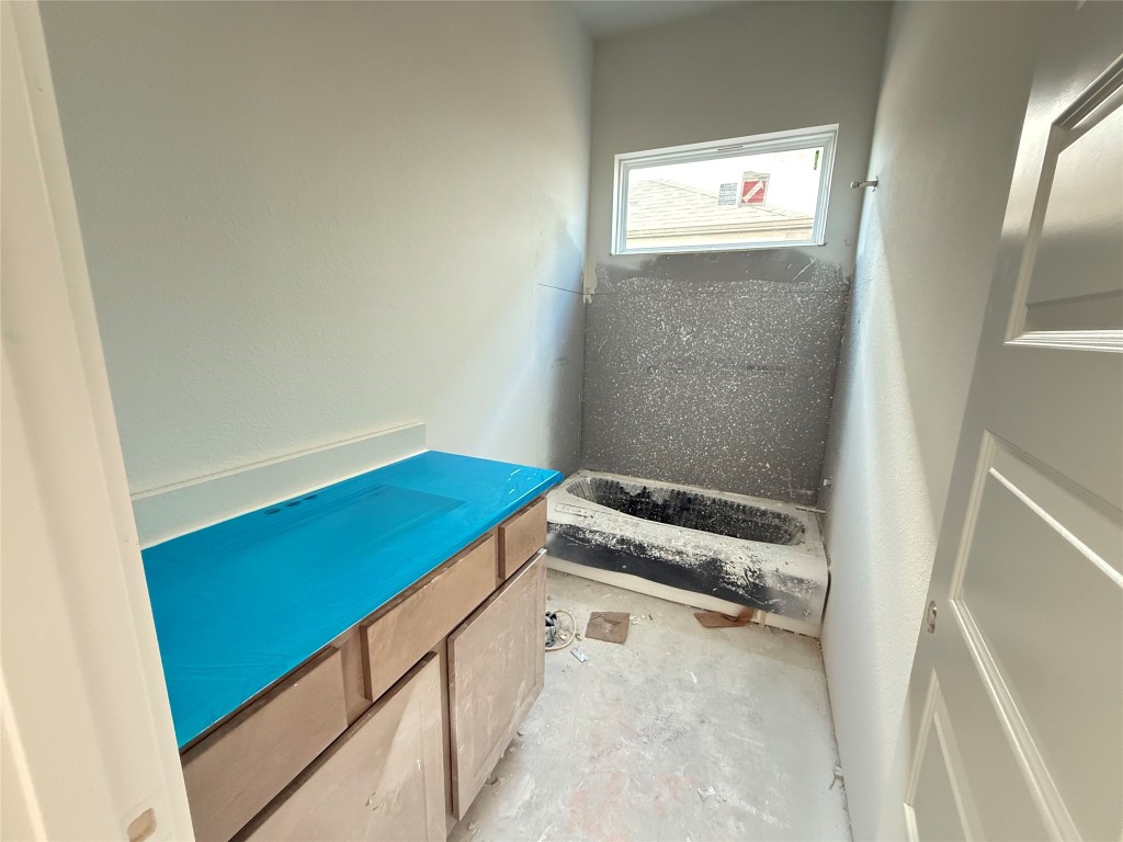 19608 Domino Champ Road Pflugerville, TX 78660 - Photo 10 of 14 a bathroom with a sink and a window
