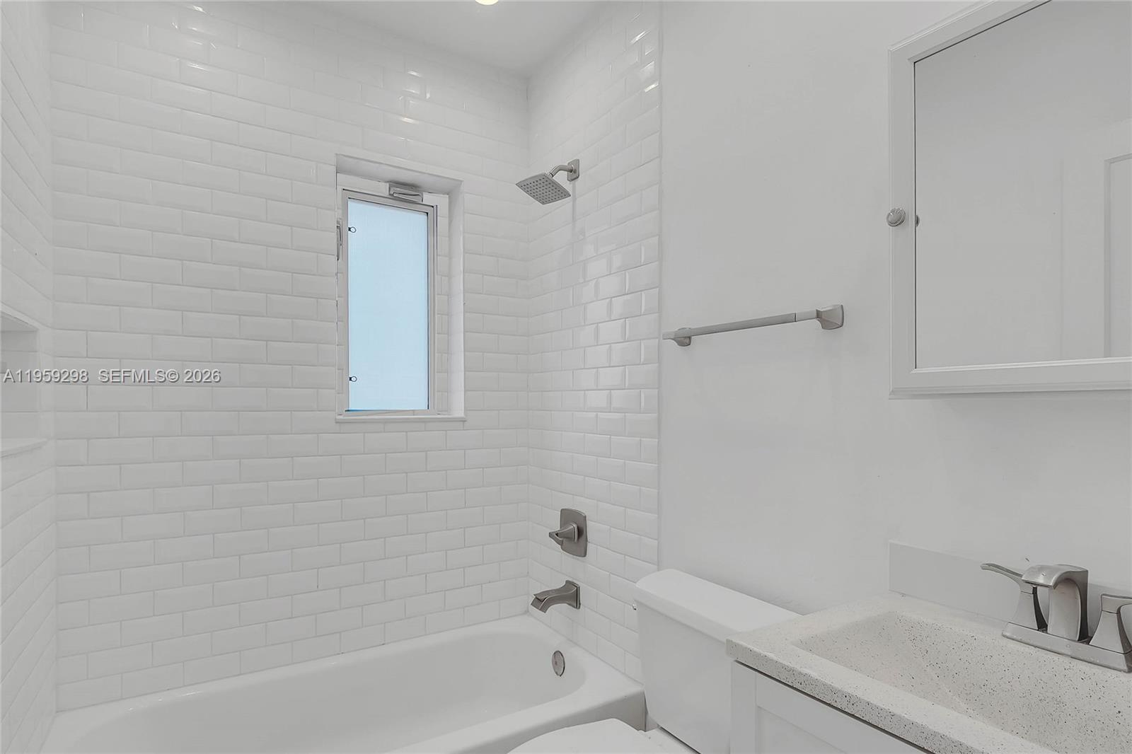 3050 Southwest 23rd Terrace Miami, FL 33145 - Photo 14 of 22 a bathroom with a bathtub shower sink vanity and toilet