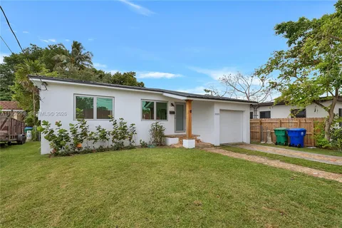 a view of a house with a yard and pathway