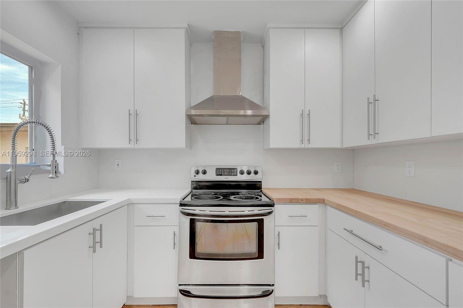 3050 Southwest 23rd Terrace Miami, FL 33145 - Photo 4 of 22 a kitchen with a stove and white cabinets